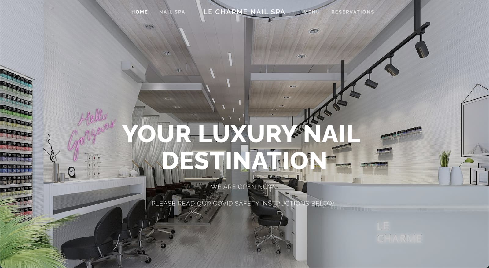 Modern, bright nail spa interior featuring manicure stations, pedicure chairs, and a pink neon sign.